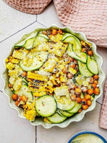 zucchini, corn and chickpea salad with cheese grated on top.