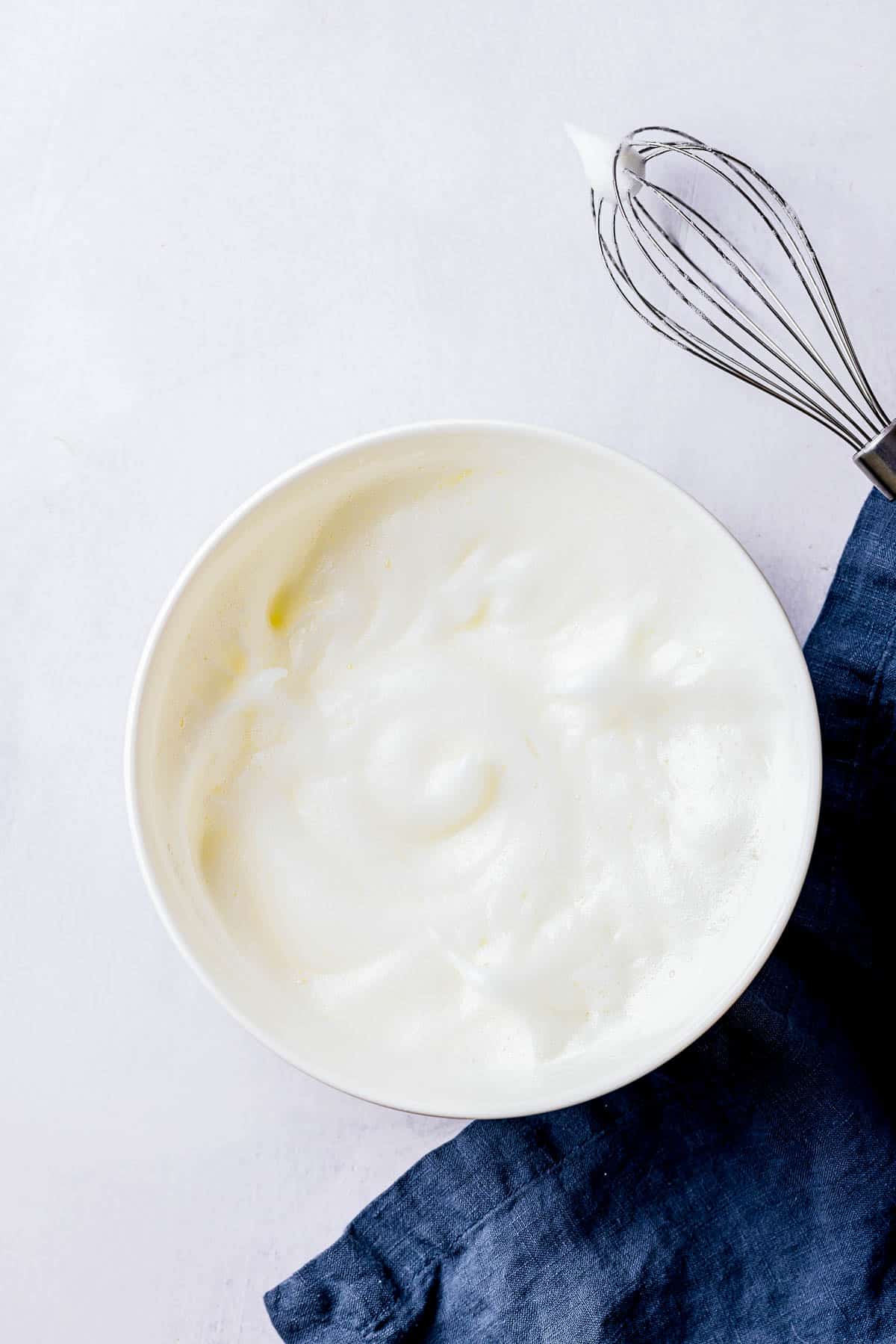 whipped egg whites in a bowl.