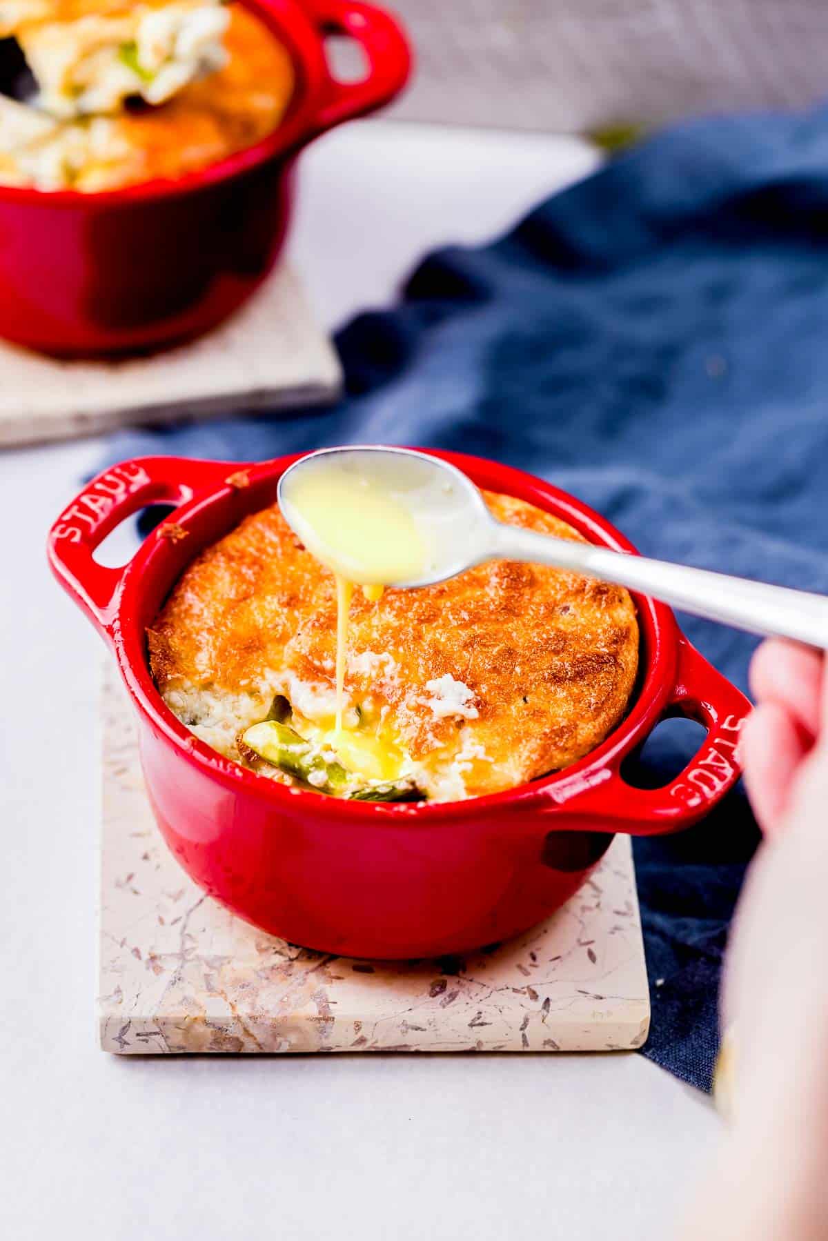 bechamel sauce being poured on a souffle.